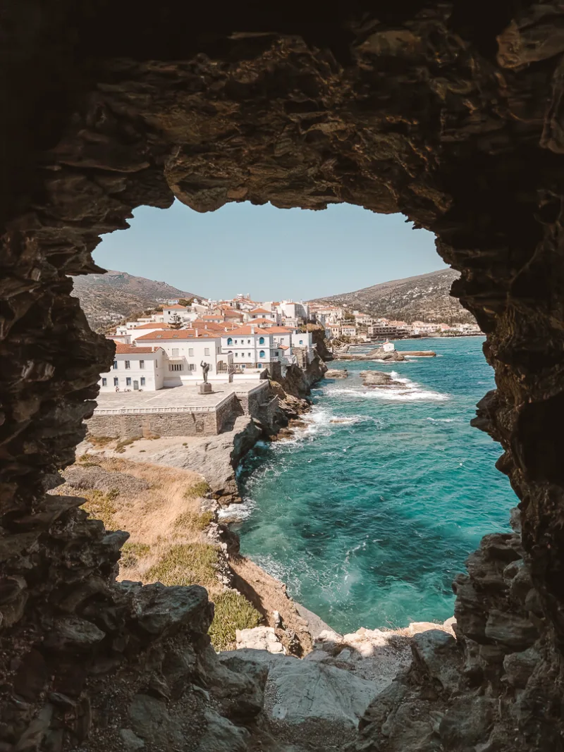view of chora looking through the rock cave at the venetian castle