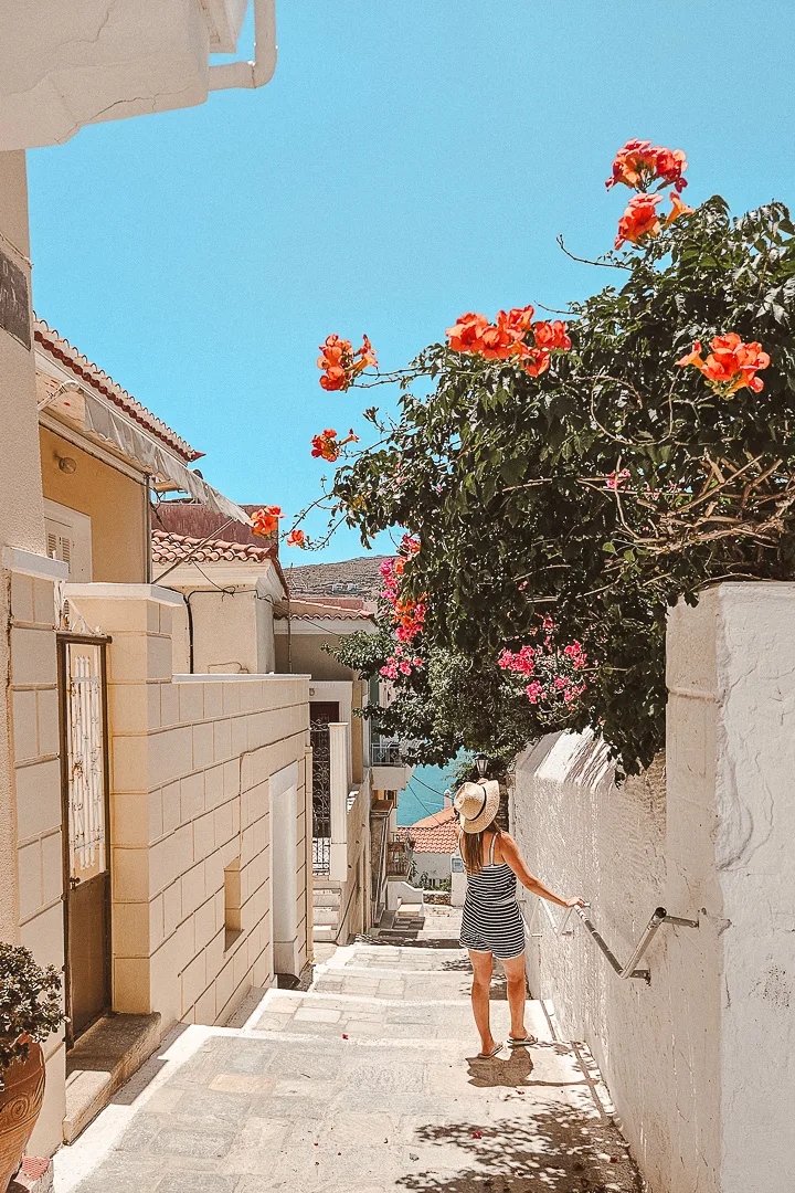 woman smelling pretty flowers on chora steps
